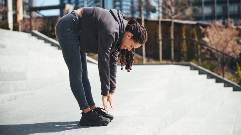 Woman performs roll down exercise