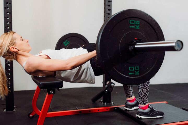 Woman performs hip thrust in gym
